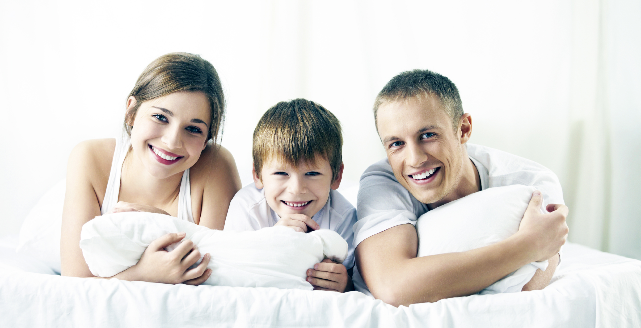 Smiling family in a bedroom at home